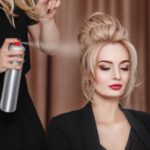 professional-hairdresser-using-hair-spray-on-client-business-woman-hair-at-beauty-salon